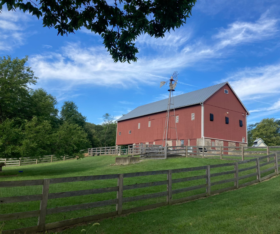Historic red barn and windmill on a sunny day